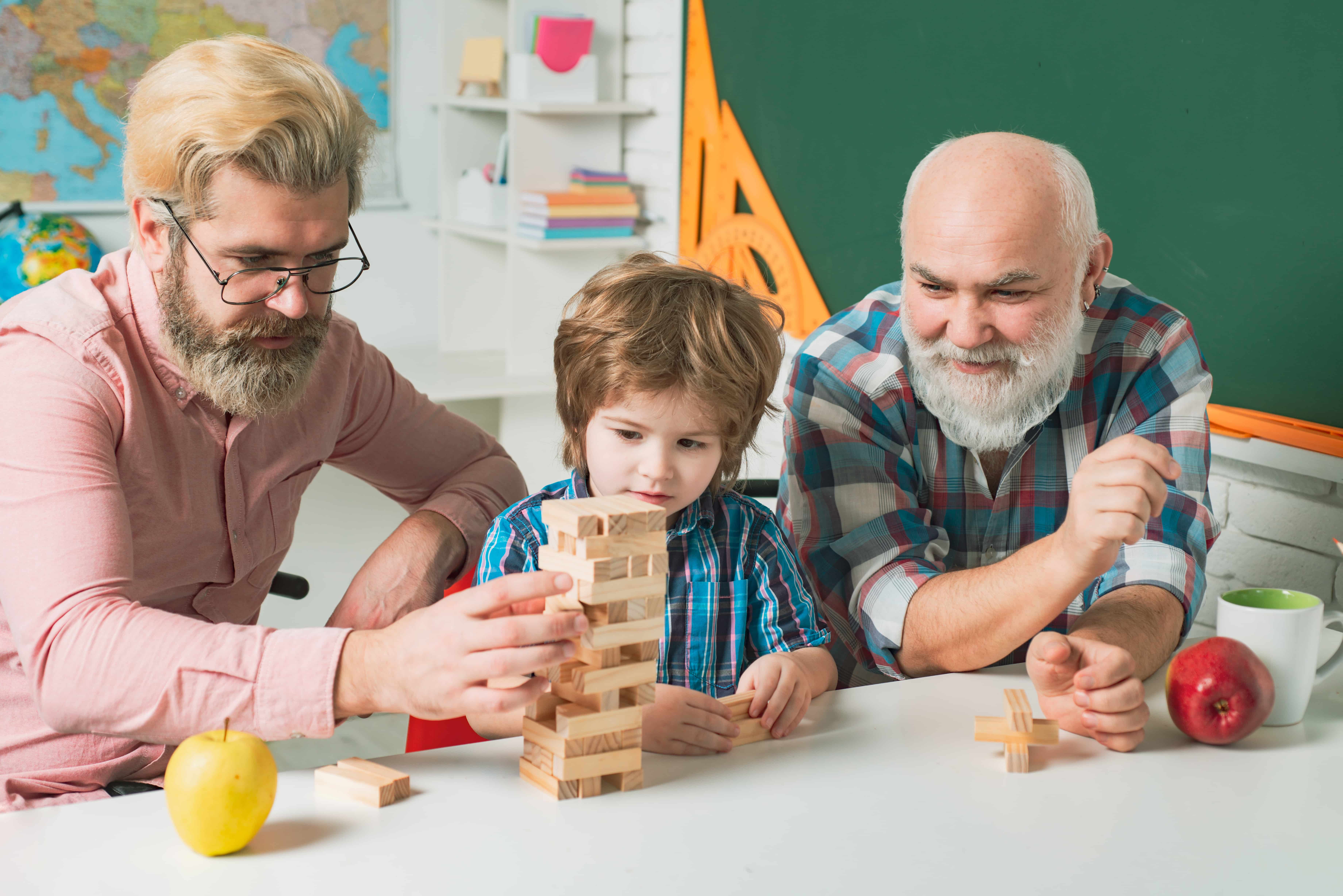 grandfather-watching-son-and-grandson-playing-board-game-at-home-games-for-family-(1)