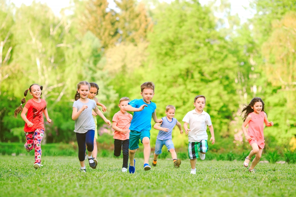 many-different-kids-boys-and-girls-running-in-the-park-on-sunny-summer-day-in-casual-clothes